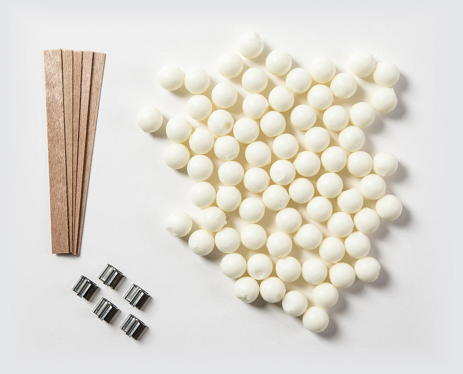 Soy Candle Making Kit with soy wax, wooden wicks, and metal clips.